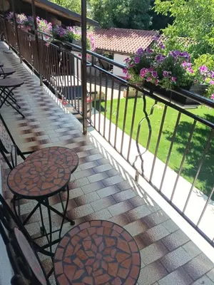 a balcony with tables and chairs and flowers at Apartma Brina 3 in Sežana