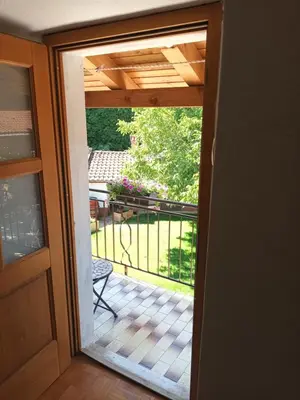 a door to a balcony with a view of a patio at Apartma Brina 3 in Sežana