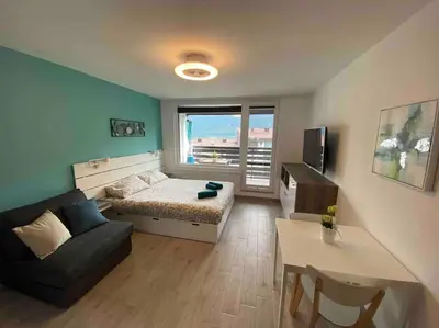 a living room with a bed and a couch at Apartma Eda, Bovec in Bovec