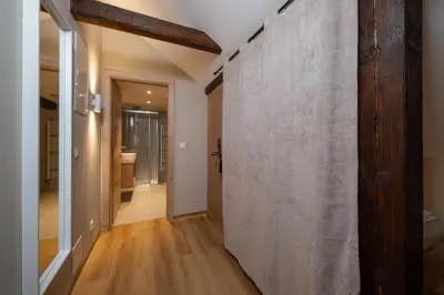 a hallway of a home with a large wall at Apartments Triglav in Mojstrana