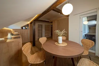 a dining room with a wooden table and chairs at Apartments Triglav in Mojstrana