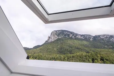 a view from the window of a mountain at River Valley Vista Apartment in Bohinjska Bela