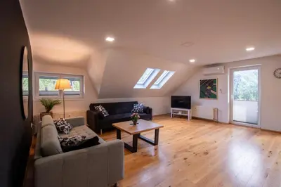 a living room with a couch and a table at River Valley Vista Apartment in Bohinjska Bela