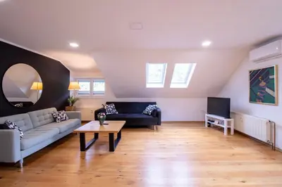 a living room with a couch and a table at River Valley Vista Apartment in Bohinjska Bela