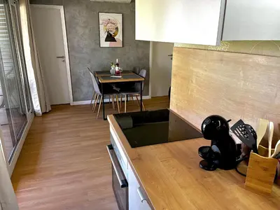 a kitchen with a table with a black cat on the counter at Premium mobile home Eden in Velenje
