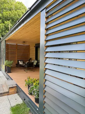 a house with a wooden deck at Premium mobile home Eden in Velenje