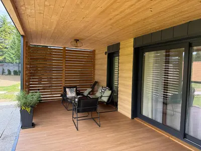 a covered patio with a table and chairs on it at Premium mobile home Eden in Velenje
