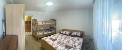 a small bedroom with a bed and a shelf at Apartma Šohen in Kočevje