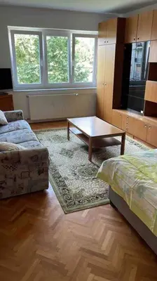 a living room with a couch and a coffee table at Spacious Apartment - green & peaceful in Ljubljana