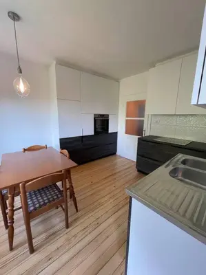 a kitchen with a table and a kitchen with a sink at Spacious Apartment - green & peaceful in Ljubljana