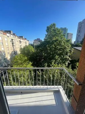 a balcony of a building with a view of a city at Spacious Apartment - green & peaceful in Ljubljana