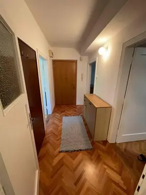 an empty room with a hallway with a wooden floor at Spacious Apartment - green & peaceful in Ljubljana