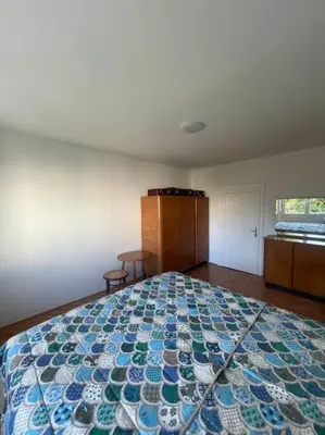 a bedroom with a bed with a blue and green quilt at Spacious Apartment - green & peaceful in Ljubljana