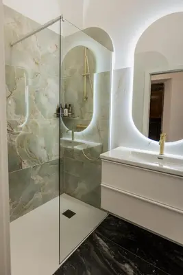 a bathroom with a glass shower and a sink at Swanky Residence, 4 stars, city centre in Ljubljana