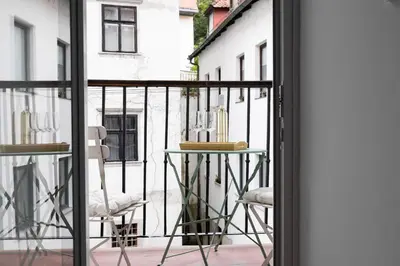 a balcony with a table and two chairs at Swanky Residence, 4 stars, city centre in Ljubljana