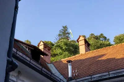 a roof with two chimneys on top of a building at Swanky Residence, 4 stars, city centre in Ljubljana