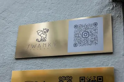 a gold sign on a wall with a dog on it at Swanky Residence, 4 stars, city centre in Ljubljana