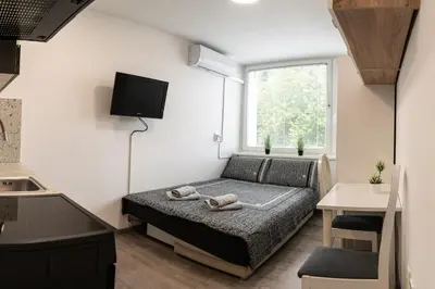a small bedroom with a bed and a window at Apartma Nadja in Maribor