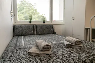 a bed with towels on it in a room with a window at Apartma Nadja in Maribor