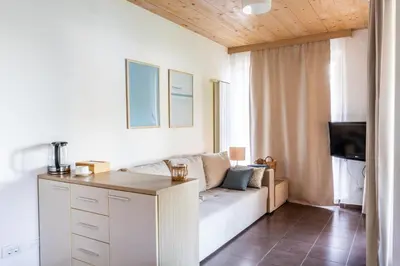 a living room with a couch and a tv at Apartment Rosemary in Topolšica
