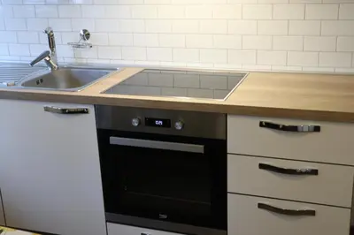 a kitchen with a sink and a black dishwasher at Holiday Home Over The River in Bovec