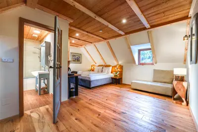 a living room with a bed and a couch at Gostilna Pri Martinu in Kranjska Gora