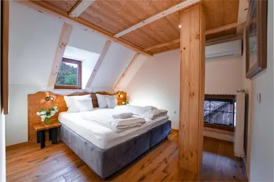 a bedroom with a large bed in a attic at Gostilna Pri Martinu in Kranjska Gora