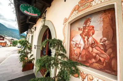 a building with a painting on the side of it at Gostilna Pri Martinu in Kranjska Gora