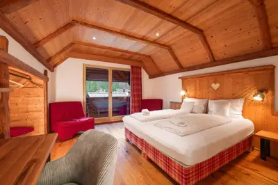 a bedroom with a large bed in a room with wooden ceilings at Gostilna Pri Martinu in Kranjska Gora