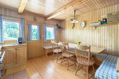 a kitchen and dining room with a table and chairs at Chalet Zlatica Velika Planina in Stahovica