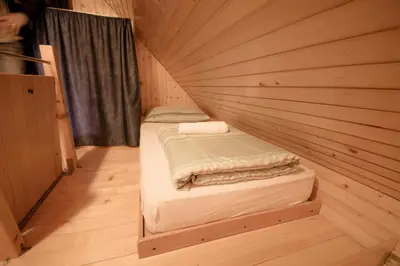 a small room with two beds in a tiny house at Chalet Zlatica Velika Planina in Stahovica