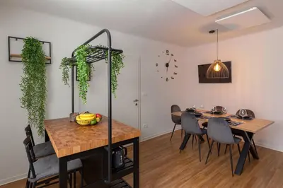 a dining room with a table and some plants at Apartments Grahek in Ljubljana