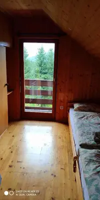 a room with a window and two beds in it at Holiday House Jezerka in Bohinj
