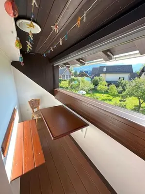 a bench sitting in a room with a window at Apartment Pirnat in Bohinj