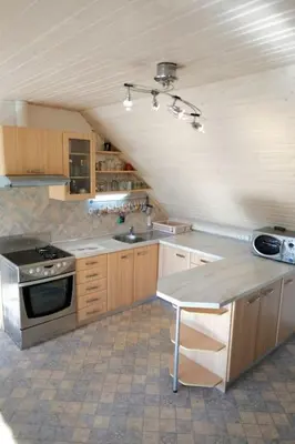 a large kitchen with a stove and a sink at Apartment Pirnat in Bohinj