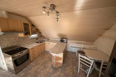 a small kitchen with a stove and a table at Apartment Pirnat in Bohinj