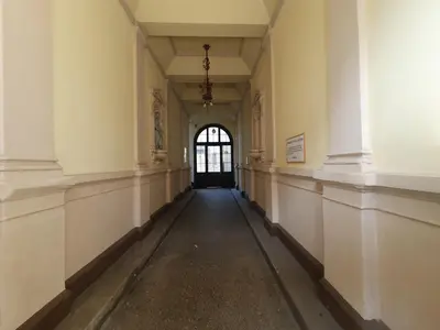 an empty hallway in a building with a window at Chic studios Wendy in centre Tour As Ljubljana in Ljubljana