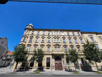 an old building with a clock tower on top of it at Chic studios Wendy in centre Tour As Ljubljana in Ljubljana