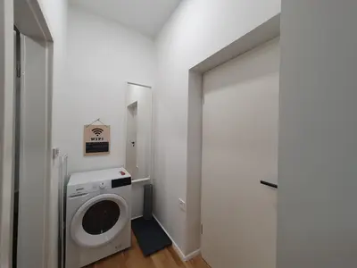 a laundry room with a washing machine and a washer at Chic studios Wendy in centre Tour As Ljubljana in Ljubljana