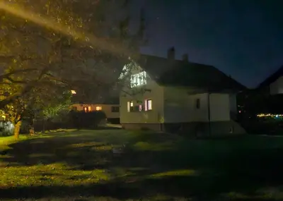 a house at night with a rainbow in front of it at Aparthouse Jana Breg in Žirovnica