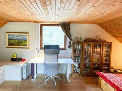 a home office with a desk and a window at Cabin in Nature in Nova Vas