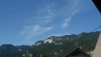 a view of the mountains from a house at Apartments Gregorc in Bled