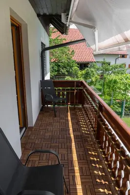 a balcony with a bench and a table at Apartments Olip in Bled