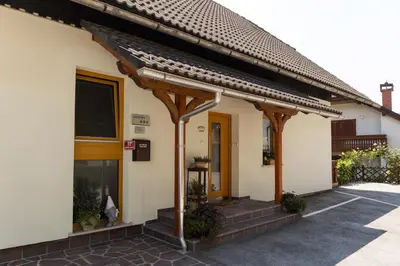 a building with a porch and a door at Apartments Olip in Bled