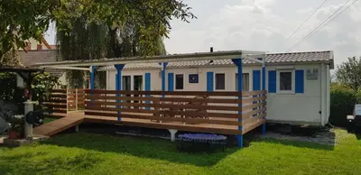 a tiny house with a porch and a deck at Guesthouse Braslovče - Celje in Braslovče