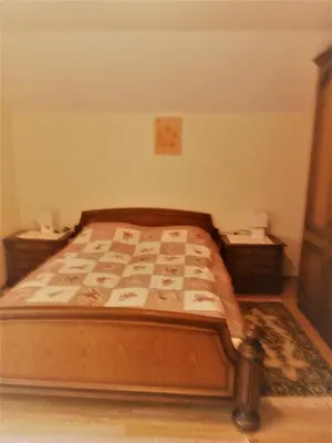 a bedroom with a bed and two night stands at Apartments Boris in Bled