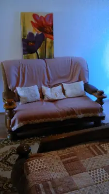 a couch with pillows sitting in a living room at Apartments Boris in Bled