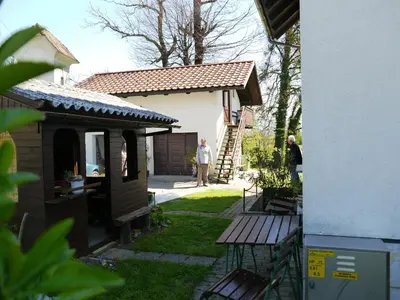 a man standing in a yard next to a house at Apartments Boris in Bled