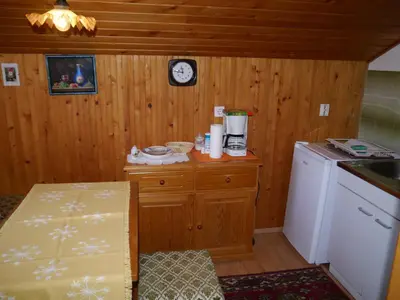 a kitchen with a counter and a clock on the wall at Apartments Boris in Bled
