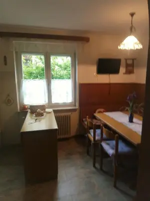 a room with a table and a dining room with a window at Apartments Boris in Bled